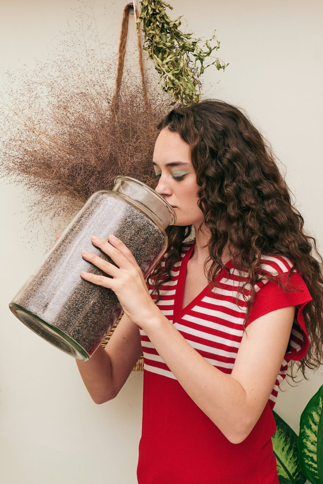 Woman smelling a jar of grains