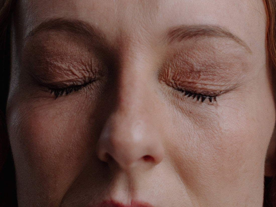 Woman with eyes closed inhaling