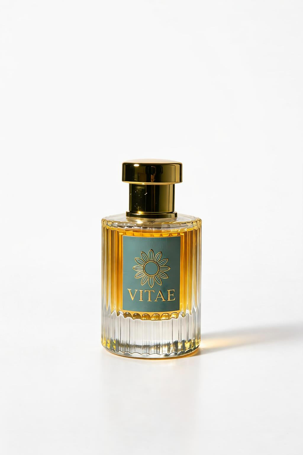 Vitae Teal Parfum extrait de parfum bottle with gold cap and signature emblem on white background