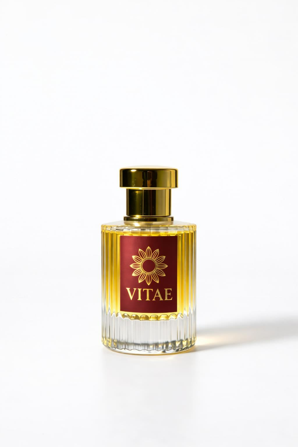Vitae Red Parfum extrait de parfum bottle with gold cap and signature emblem on white background