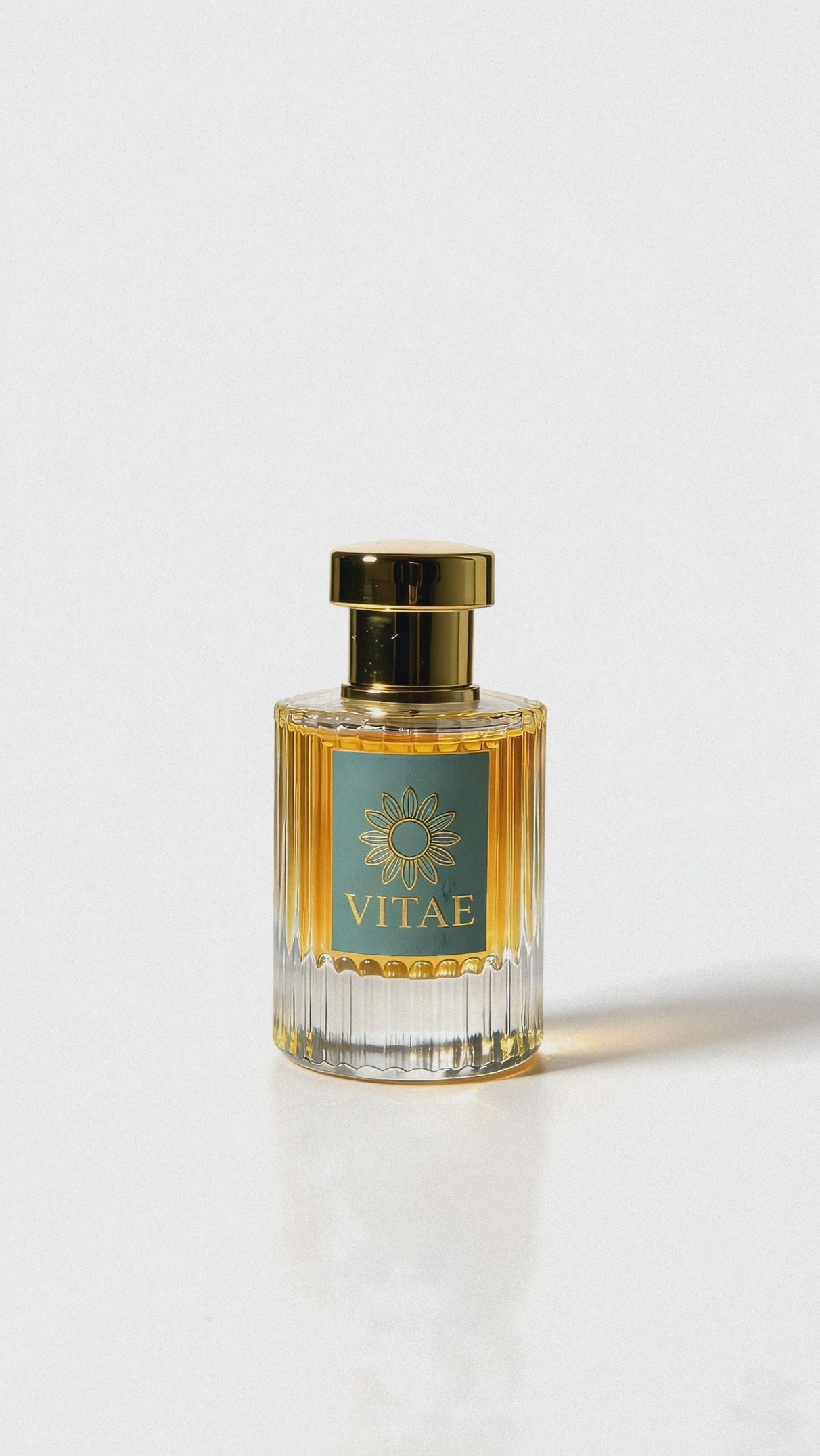 Vitae Parfum extrait de parfum bottle with gold cap and signature emblem rotating on white background